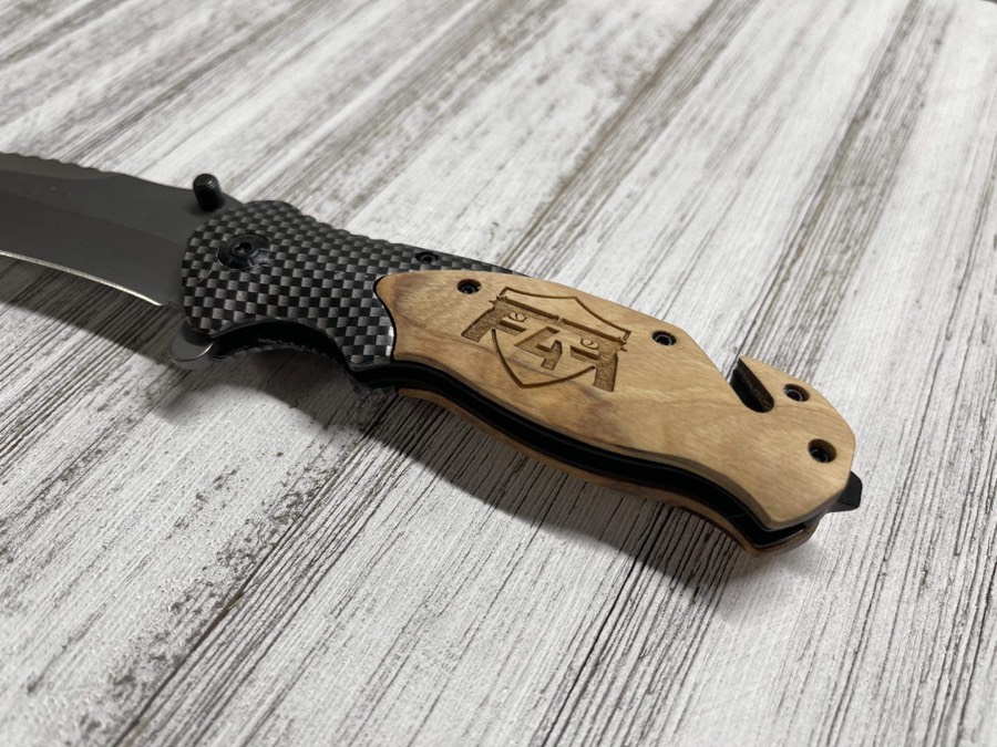 Pocket knife with an engraved wood handle
